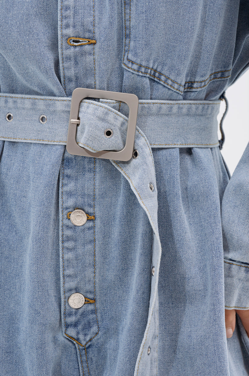 Close-up of the NOT TODAY EXTREME OVERSIZED DENIM JUMPSUIT in light blue, featuring silver buttons and an adjustable waist belt with a square silver buckle that cinches the waist, enhancing its wide leg silhouette.