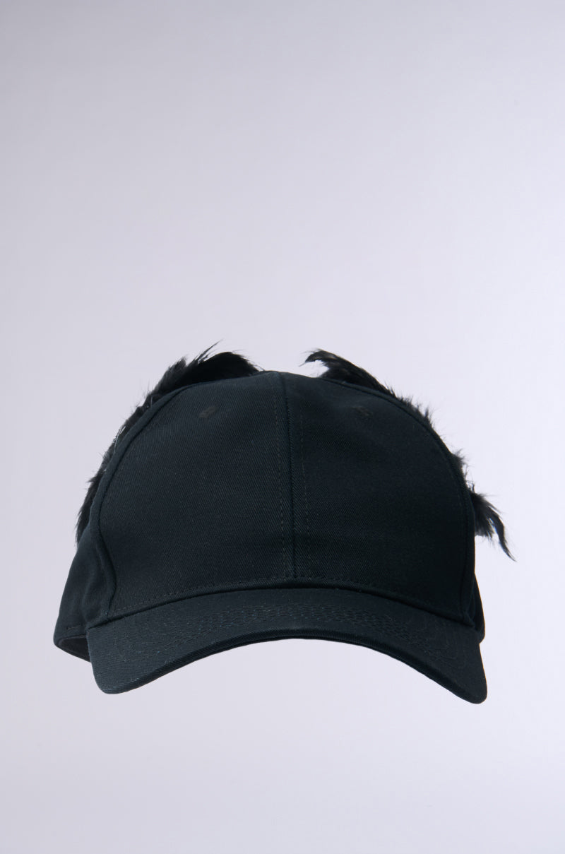 The BRB FLYING AWAY HAT is a black baseball cap featuring small black feathers on the sides. Set against a plain light gray background, it includes an adjustable back strap for optimal comfort.