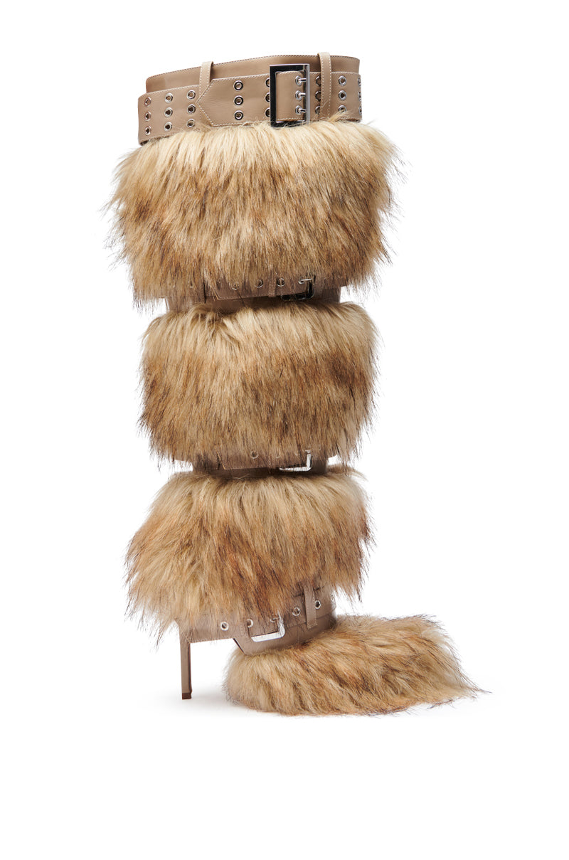 The AZALEA WANG AMALBERT BROWN MULTI FUR AND BUCKLES BOOT features a knee-high, light brown faux fur shaft with multiple tan leather straps and buckles, plus a pointed toe and stiletto heel for a bold, stylish look.