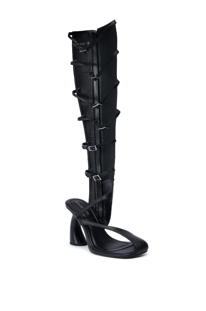 Introducing the AZALEA WANG ANDRIUS BLACK GLADIATOR SANDAL: a one-of-a-kind high-heeled shoe showcasing a striking gladiator-style knee-high shaft crafted from faux leather, accented by multiple front buckles. This black sandal features an open square toe paired with a chunky block heel.