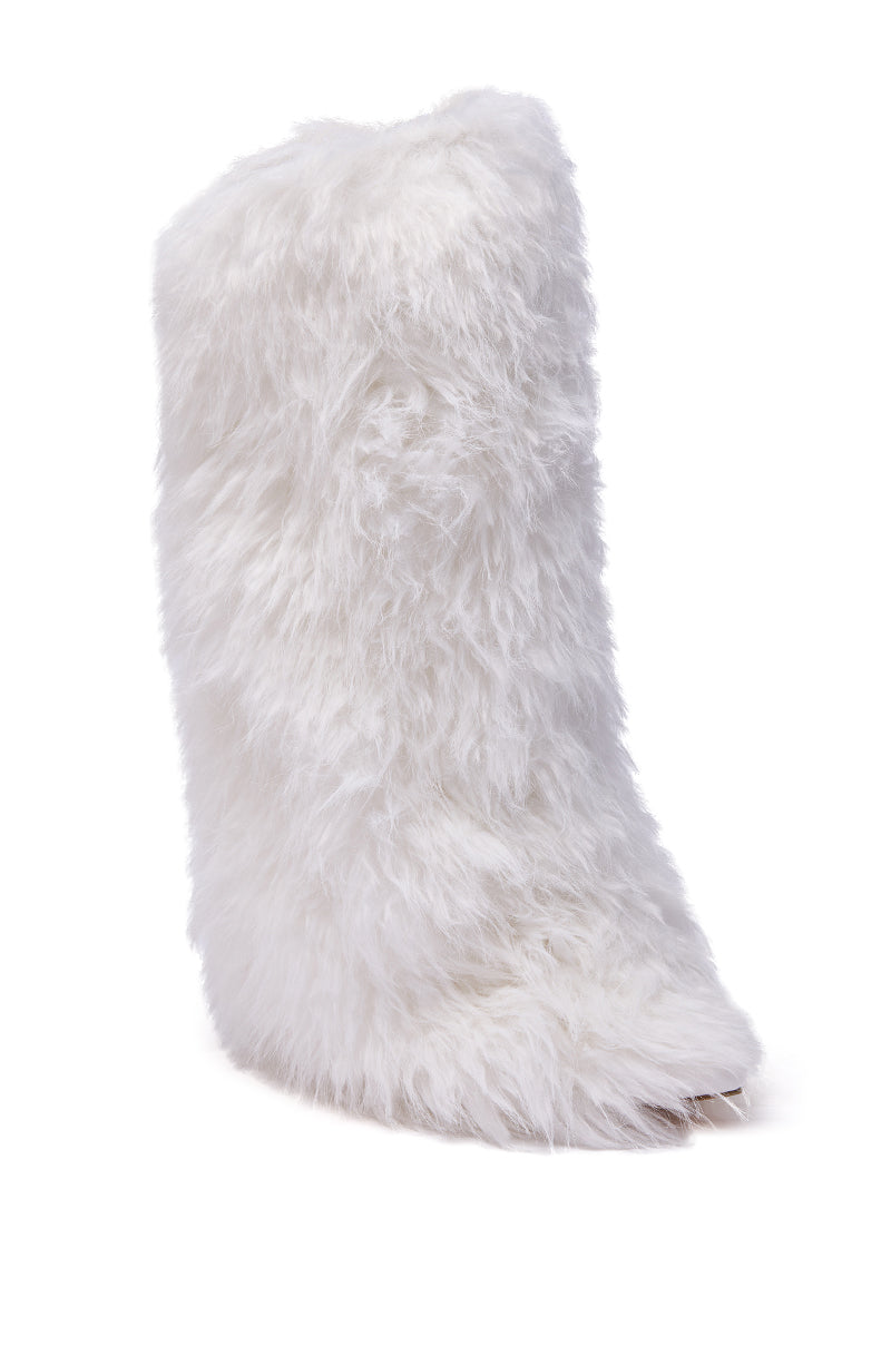 The AZALEA WANG ARETE WHITE FUR STILETTO BOOT stands upright against a white background, showcasing its knee-high design, bold high stiletto heel, and fluffy white faux fur for a striking look.