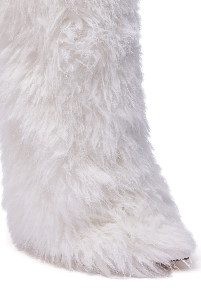 A close-up of the AZALEA WANG ARETE WHITE FUR STILETTO BOOT highlights its fluffy white fur and pointed toe against a white background.