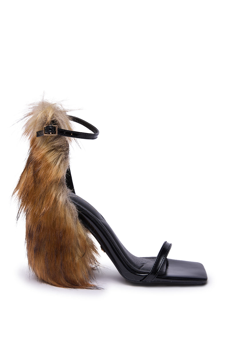The AZALEA WANG ARETTE BLACK SANDAL WITH BROWN FUR features a chunky heel, square toe, ankle strap, and soft brown faux fur on the heel and back.