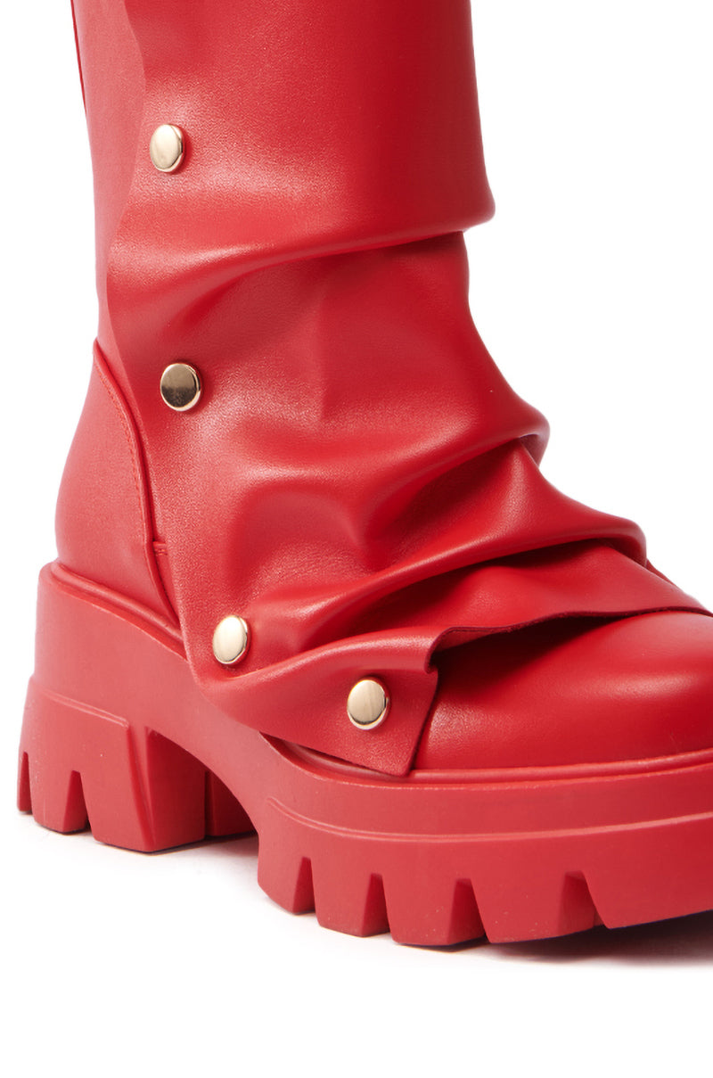 Close-up of the AZALEA WANG BHARTI Red Snap Detail Bootie, featuring a chunky treaded sole and folded design. Metallic snap buttons on the side add texture to its smooth, matte faux leather finish.