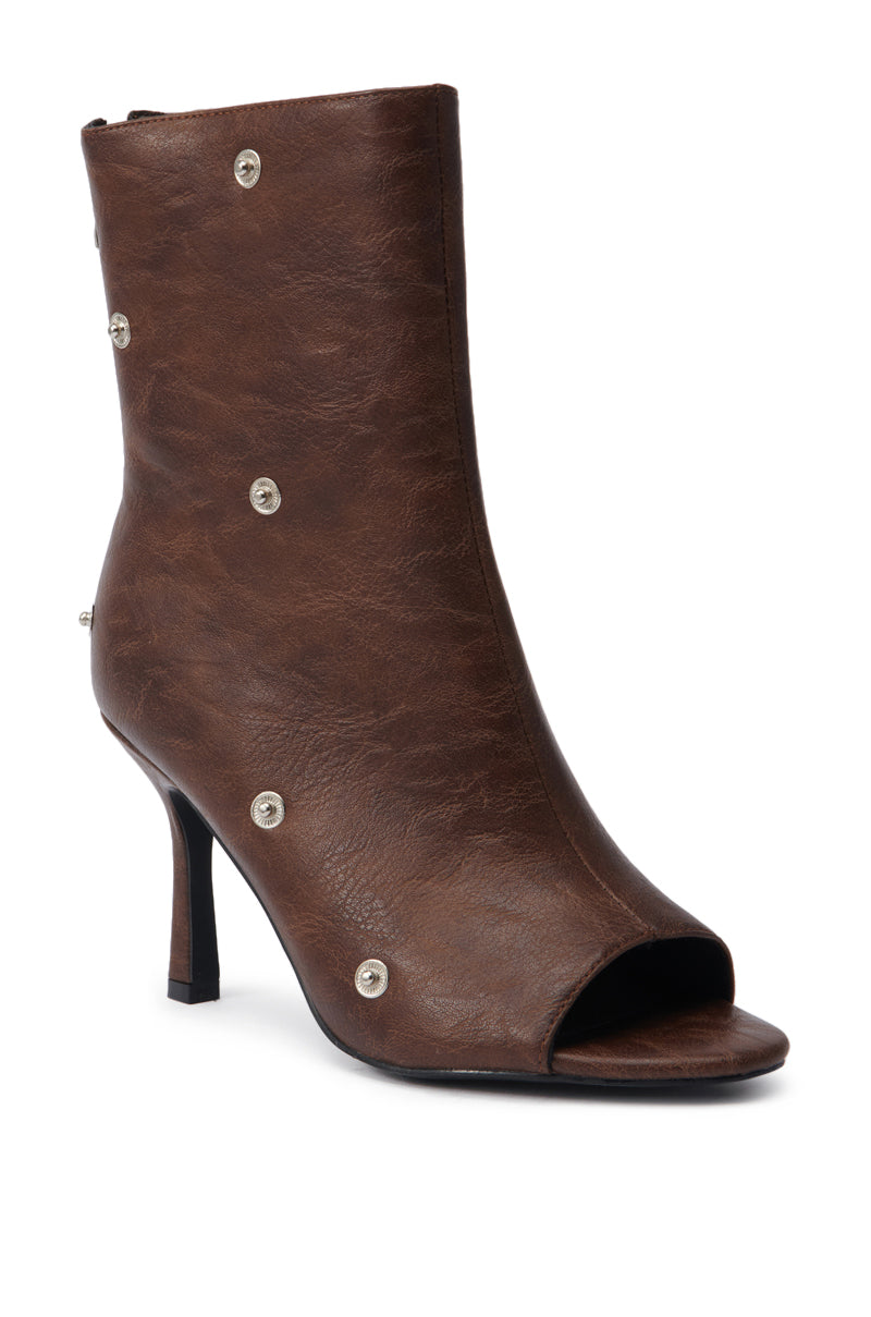 The AZALEA WANG BIRD SONG BROWN SNAP DETAIL OPEN TOE BOOTIE features a brown faux leather design, stiletto heel, almond-shaped peep toe, silver snap details, and a slightly slouched texture.