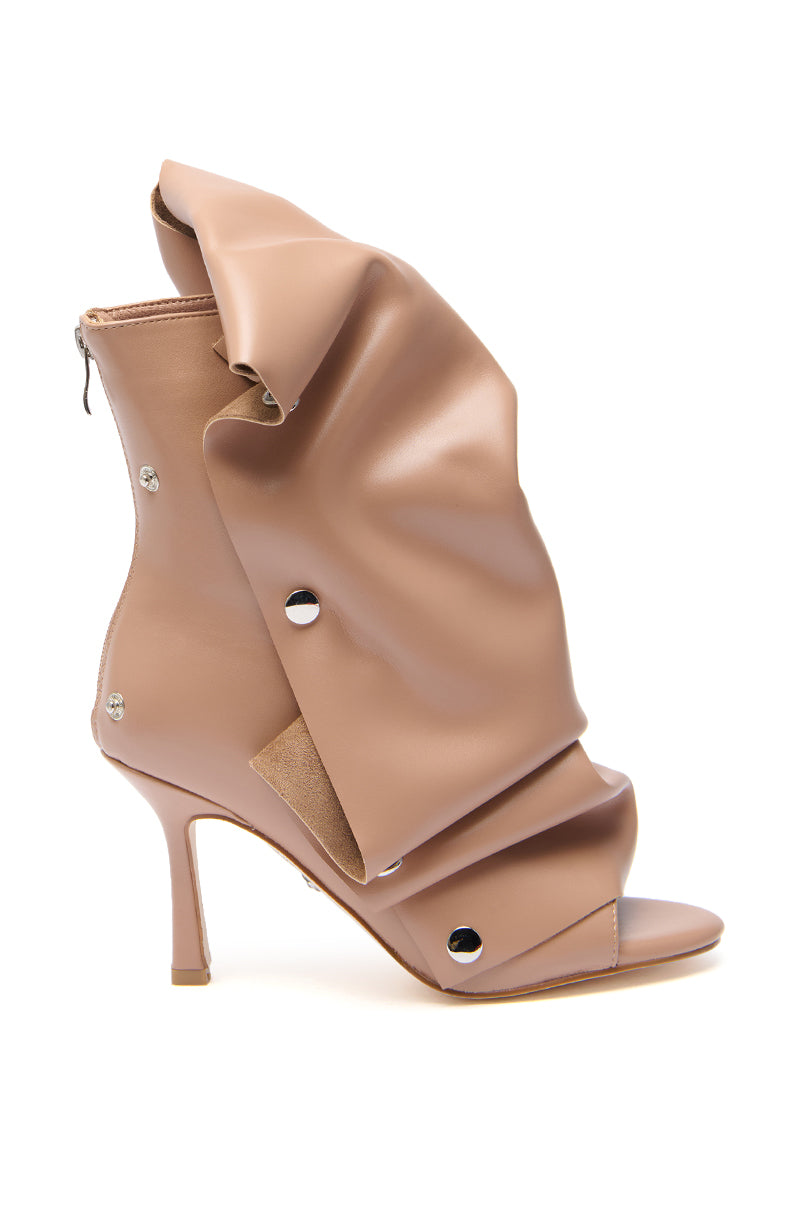 The AZALEA WANG BIRDSONG SNAP OPEN-TOE BOOTIE IN MOCHA features a sculptural tan faux patent leather design with folded and draped material, silver snaps, peep toe, stiletto heel, and back zipper.