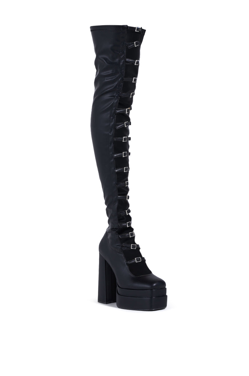 The AZALEA WANG BRYNNE BLACK CHUNKY PLATFORM BOOT showcases sleek faux leather, a high chunky heel, and vertical rhinestone buckles. This stylish boot features a fitted design with a slightly pointed toe.