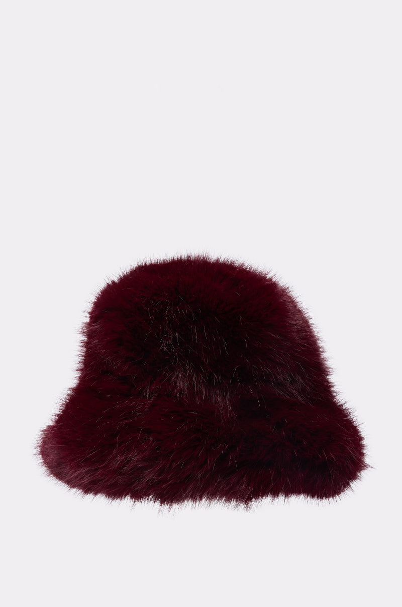 The ELEVATED FAUX FUR BUCKET HAT features a deep burgundy plush fabric with a soft, fluffy texture, making it a cozy winter hat. Shown against a plain white background.