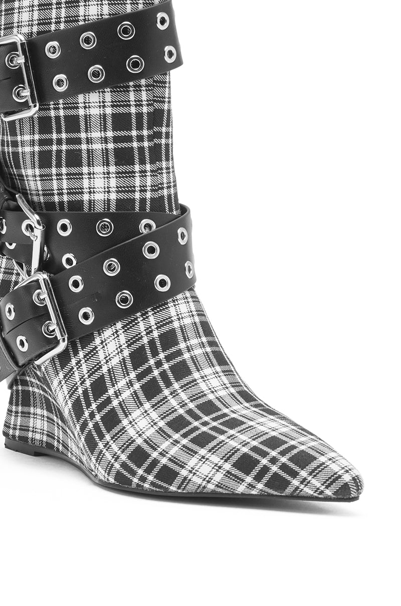 The AZALEA WANG CHALKIS BLACK WHITE PLAID BUCKLE WEDGE BOOTIE is a pointed-toe bootie with black and white plaid, multiple black straps, silver eyelets, and buckle accents.