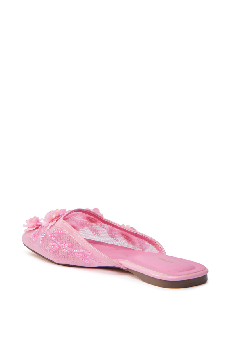 The AZALEA WANG CHERINA PINK FLAT WITH EMBELLISHMENT is a charming pink slipper adorned with floral embroidery, decorative flowers on top, and embellished slip-ons. Designed for casual wear with a flat sole, it stands out against the plain white background.