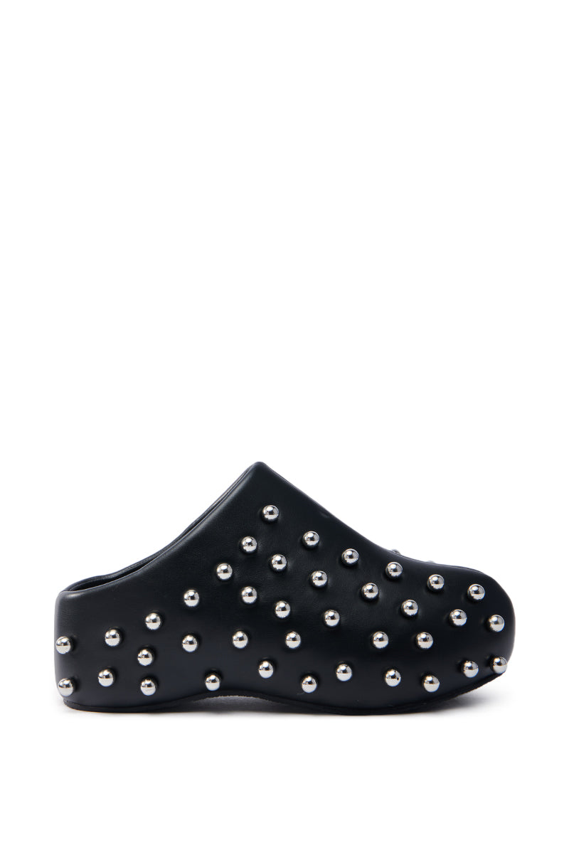 The AZALEA WANG DARWIN STUD FLAT CLOG IN BLACK is a black vegan leather shoe with a flatform sole and numerous metallic studs, viewed from the side against a white background.