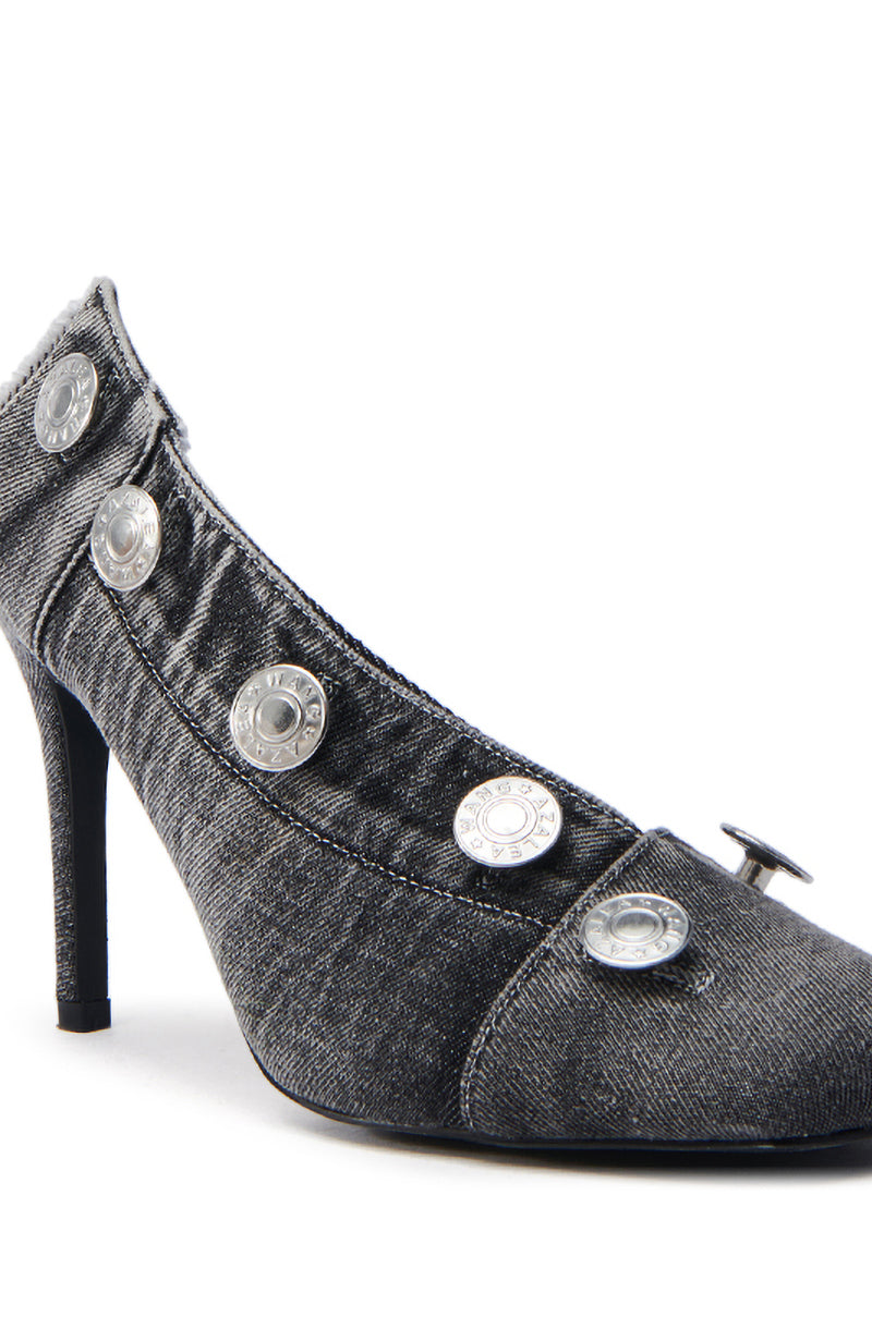 The AZALEA WANG EBRIMA DENIM STILETTO PUMP features dark fabric with silver button embellishments along the sides, a pointed toe, and a slender heel for an elegant, unique design.