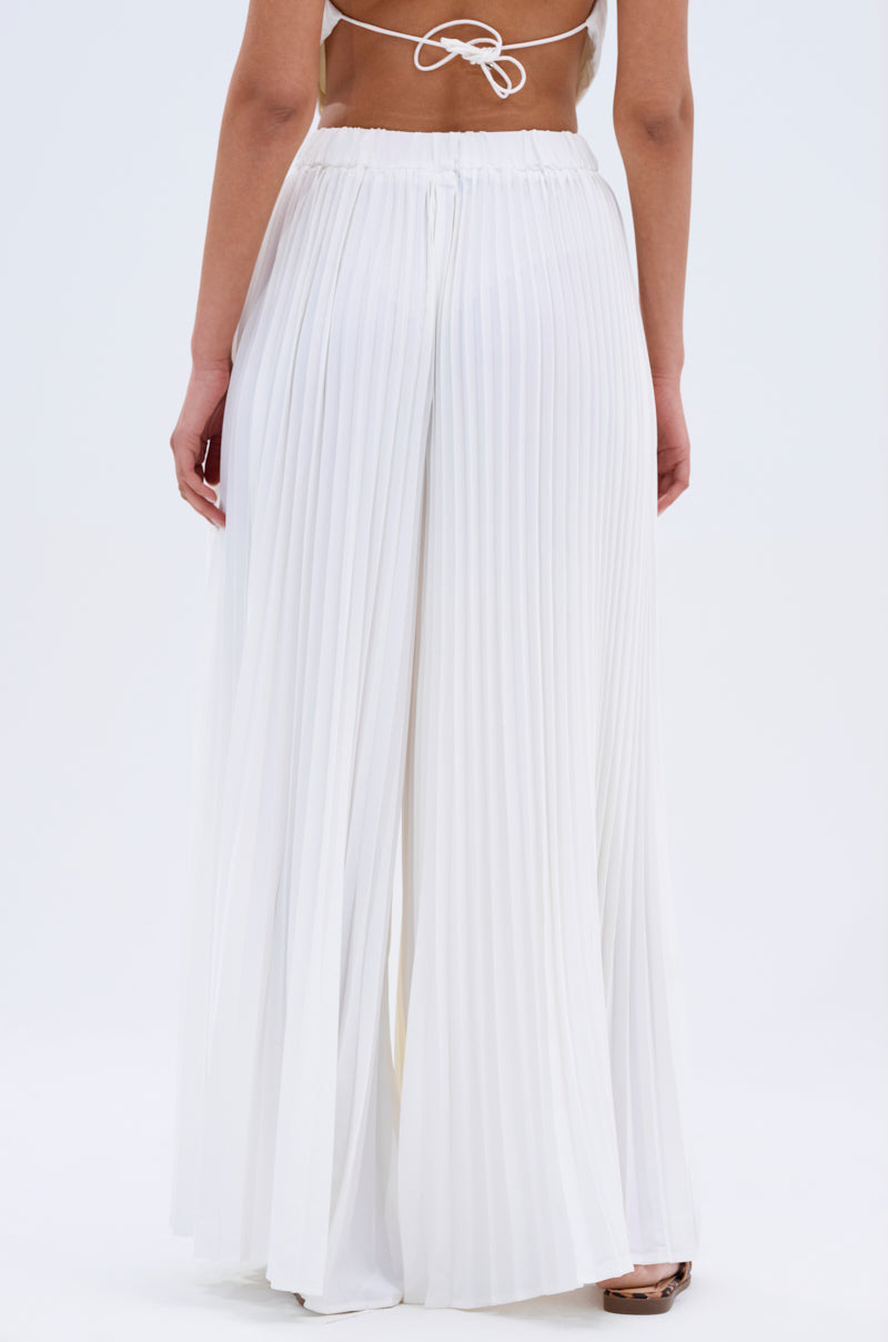 A person wearing high-waisted, wide-leg FLY INTO THE AIR PALAZZO PANT and a backless top, shown from the back against a plain light background.