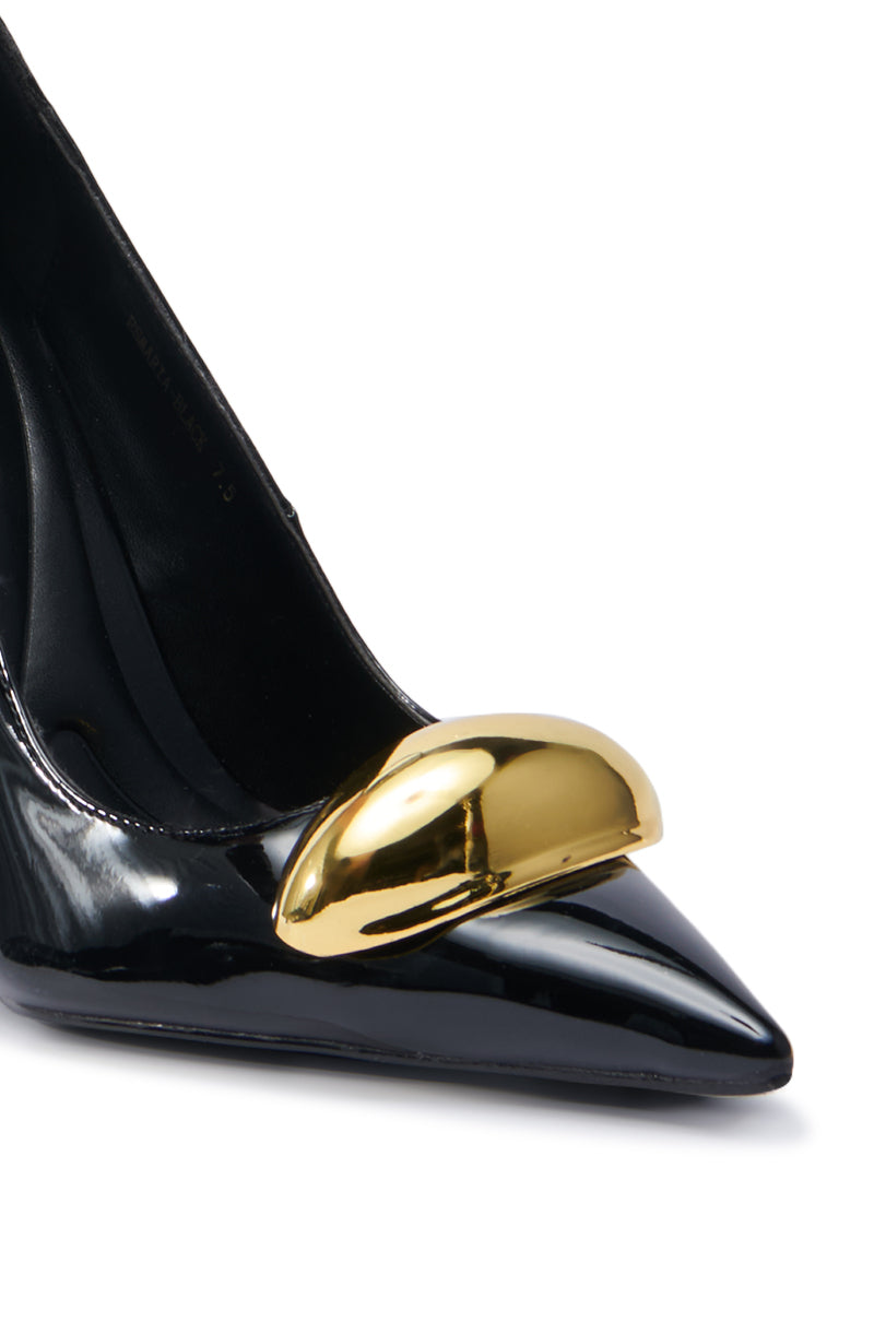 The AZALEA WANG ESMARIA BLACK STILETTO PUMP is beautifully captured in a close-up, showcasing its sleek pointed toe and a prominent gold metallic accent at the front. Made from faux leather, this stylish shoe exudes sophistication and features a comfort cushion insole for enhanced ease.