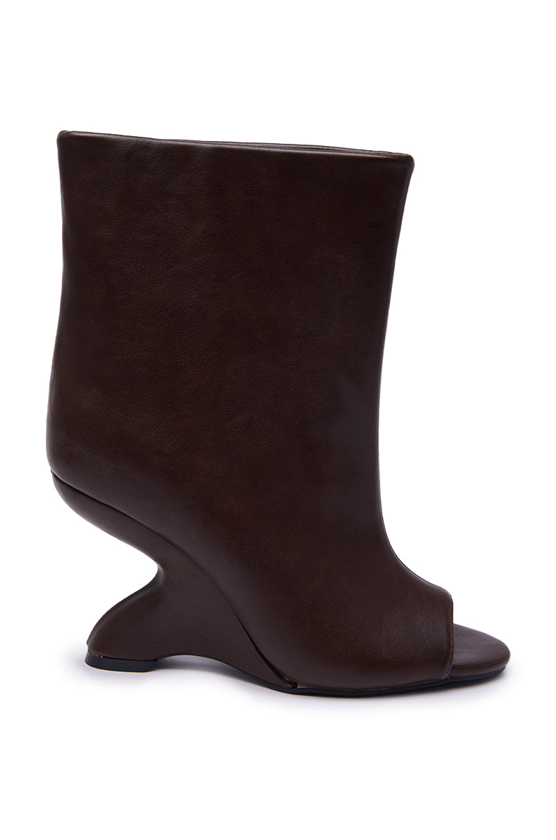 The AZALEA WANG FAOI BROWN INVERTED WEDGE OPEN-TOE BOOTIE is a high-fashion, modern faux leather bootie with a sculptural curved heel, shown against a white background.