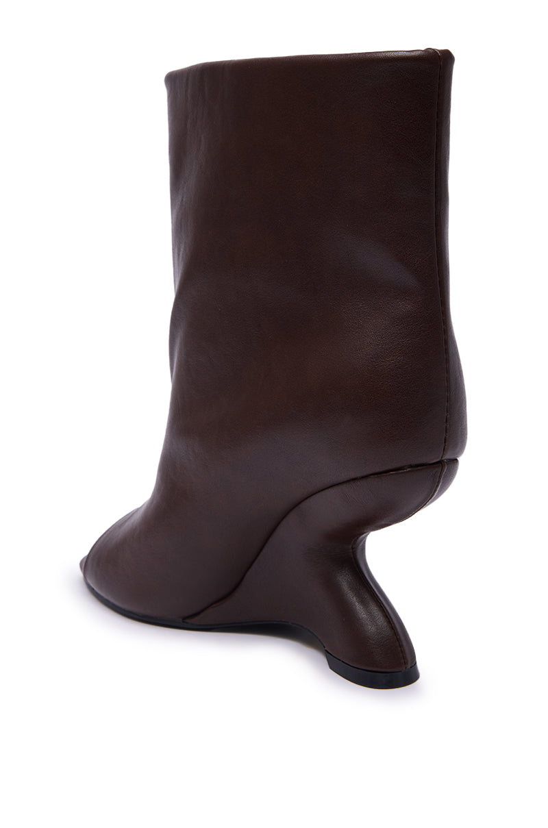 The AZALEA WANG FAOI Brown Inverted Wedge Open-Toe Bootie is shown in brown faux leather with a smooth finish and a sculptural curved heel, photographed from the rear side on a white background.