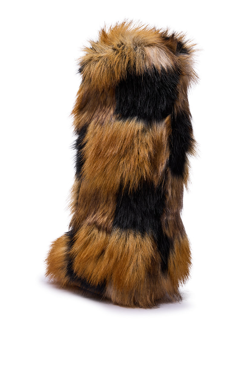 The AZALEA WANG FENNEC MULTI PATCH WORK FUR KNEE HIGH BOOT features tall, rectangular panels covered in fluffy, multicolored faux fur in brown, black, and tan shades, shown against a white background.