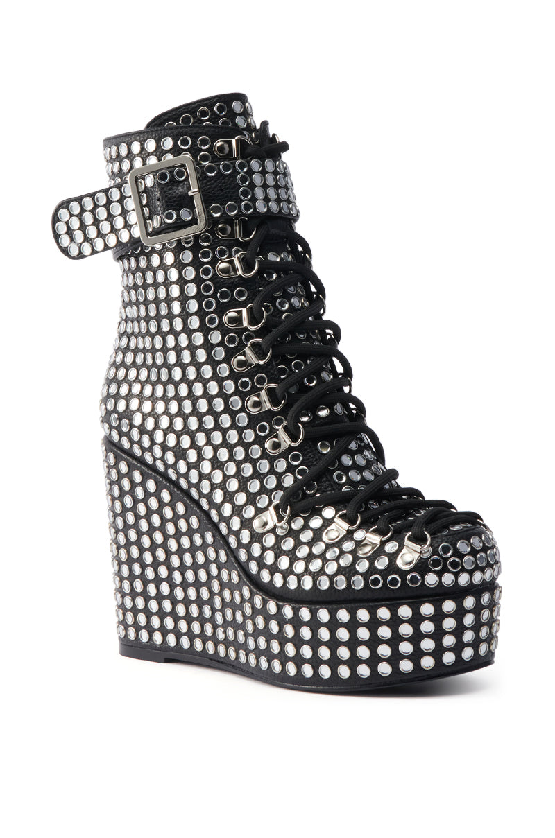 The AZALEA WANG FERDY BLACK PLATFORM EMBELLISHED BOOTIE features black laces, a metal buckle ankle strap, a chunky sole, and is covered in shiny rhinestone-studded silver studs.