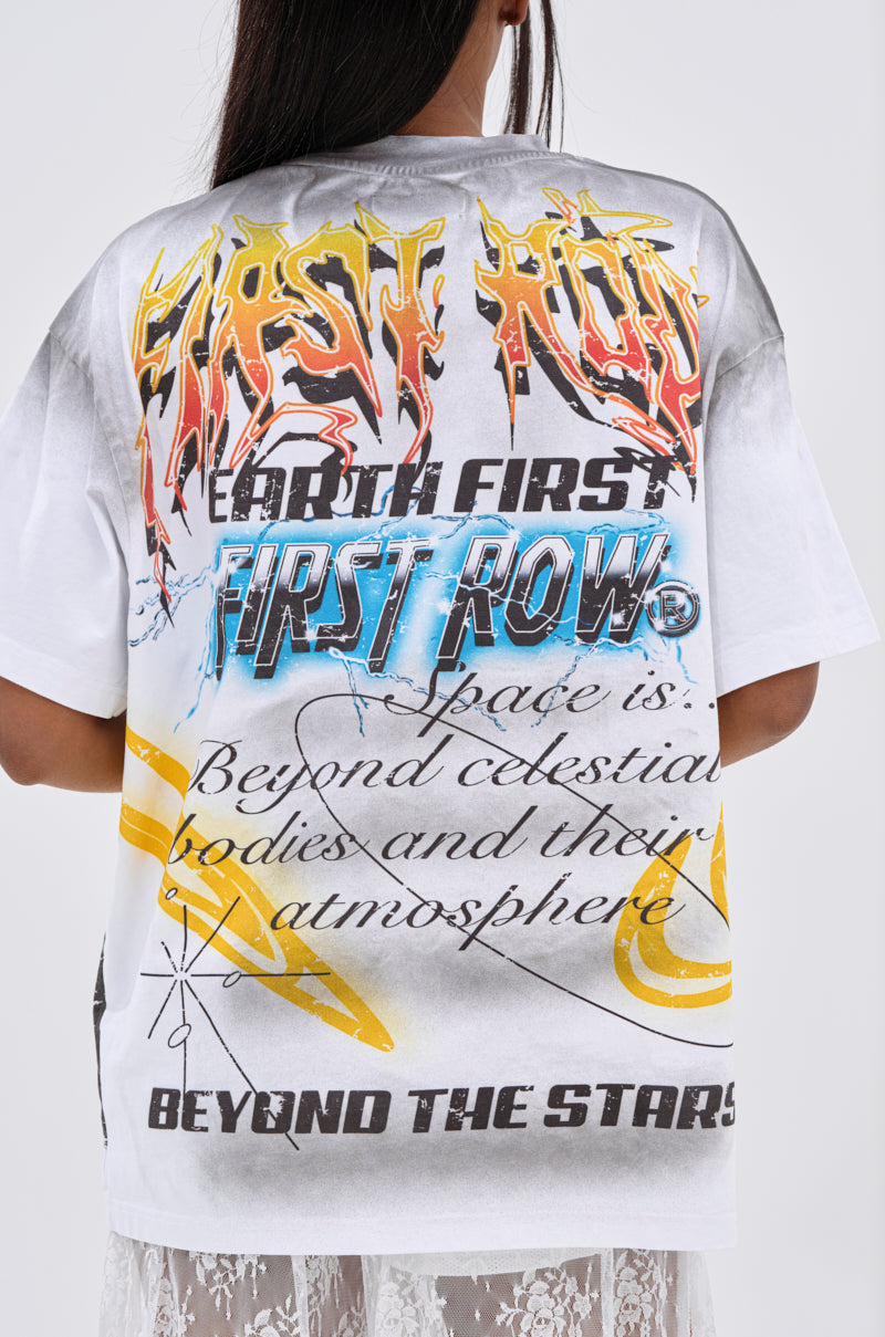 A person with long dark hair wears the NEW WORLD OVERSIZED GRAPHIC TEE, featuring bold streetwear text and abstract back designs with phrases like “FIRST ROW,” “EARTH FIRST,” and “BEYOND THE STARS.”.