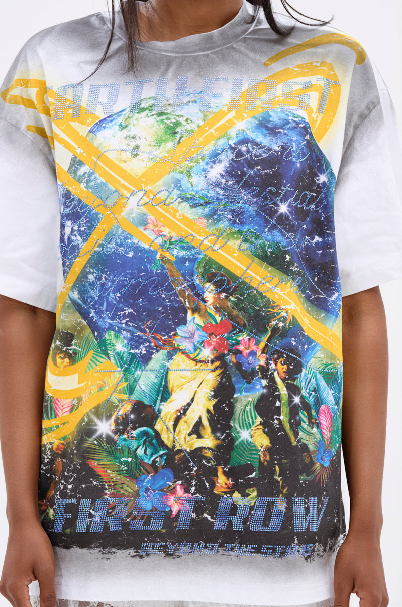 Someone sports the NEW WORLD OVERSIZED GRAPHIC TEE, featuring a bold planetary motif—Earth, yellow lines, tropical plants, flowers, abstract figures—and “FIRST ROW” with streetwear-inspired text across the front.
