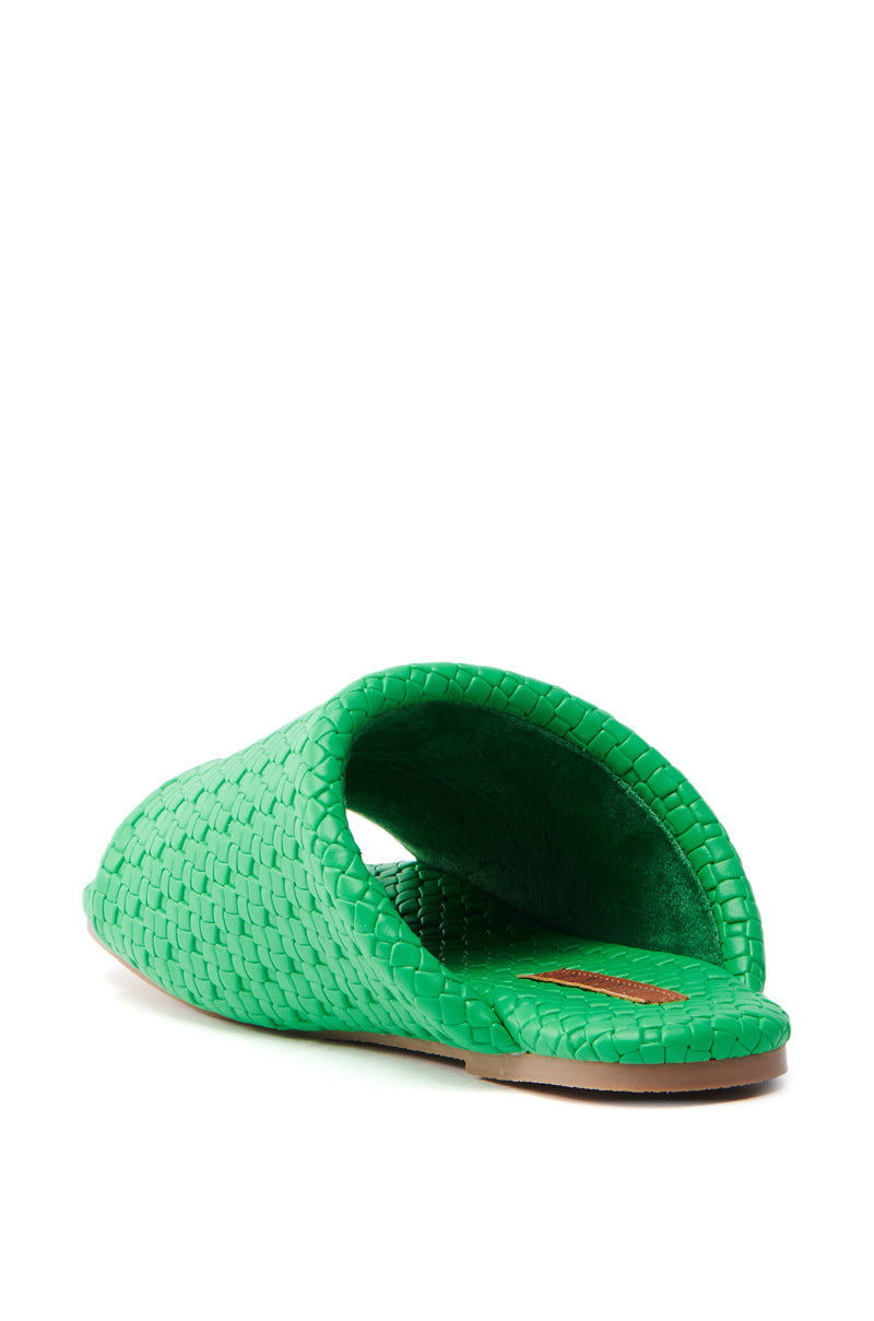 The AKIRA GAIA Green Braided Flat Slip-On Sandal features a woven-textured slide design, intricate detailing, an open-toe, and a flat sole. Made of faux leather, it offers both style and comfort from a front angle view for everyday wear.