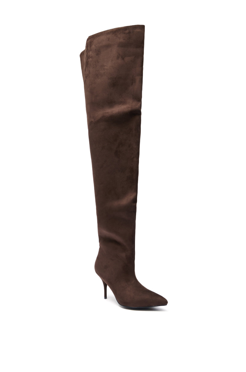 The AZALEA WANG HALINA CHOCOLATE THIGH HIGH BOOT is a brown, faux suede thigh-high boot featuring a pointed toe and slim stiletto heel, displayed against a white background.