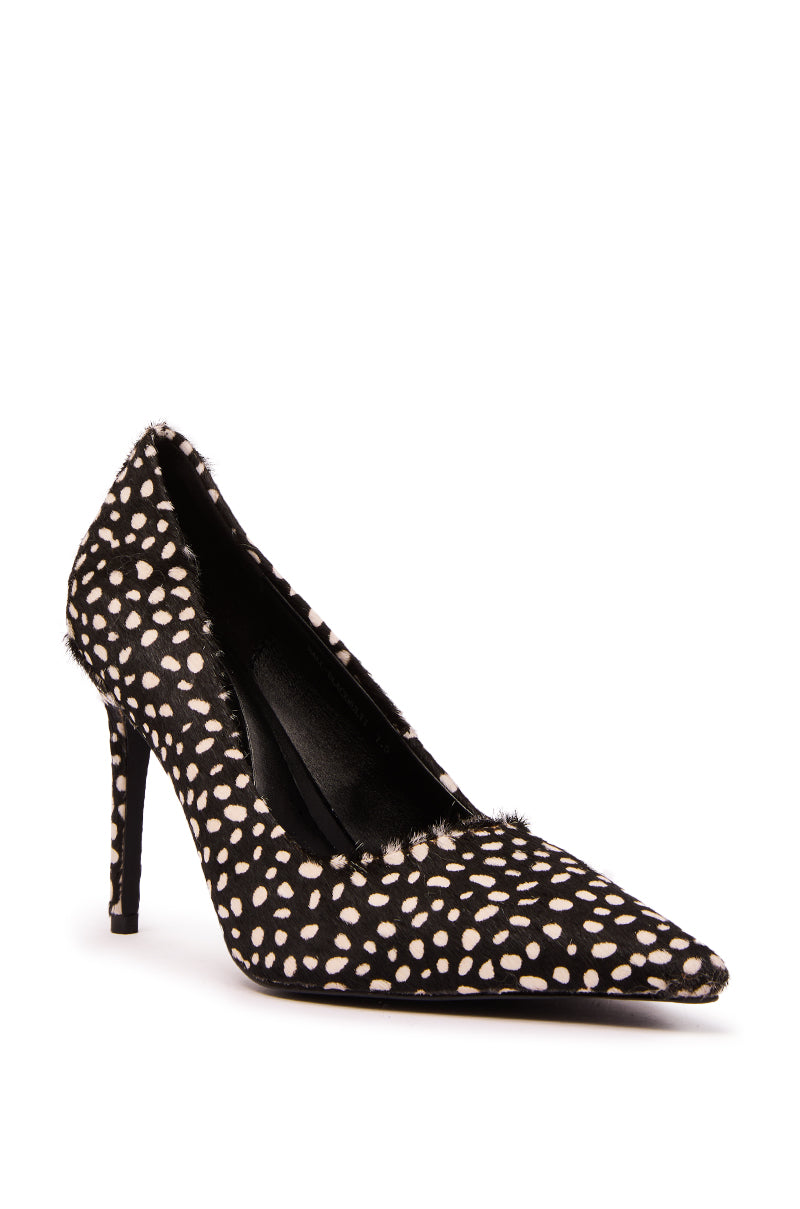 The AZALEA WANG HALL BLACK MULTI SPOTTED PONY HAIR PUMP is a black stiletto heel with a pointed toe, white polka dots, and a textured, pony hair finish.