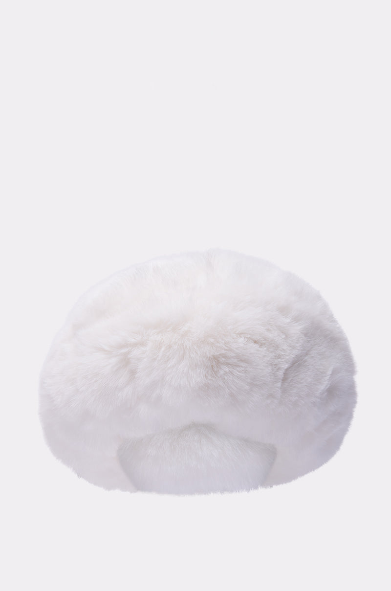 The LUXE JENNY FAUX FUR HEADBAND IN WHITE, a fluffy round accessory, is photographed against a plain light background and can also be worn as a cozy hat for extra warmth.