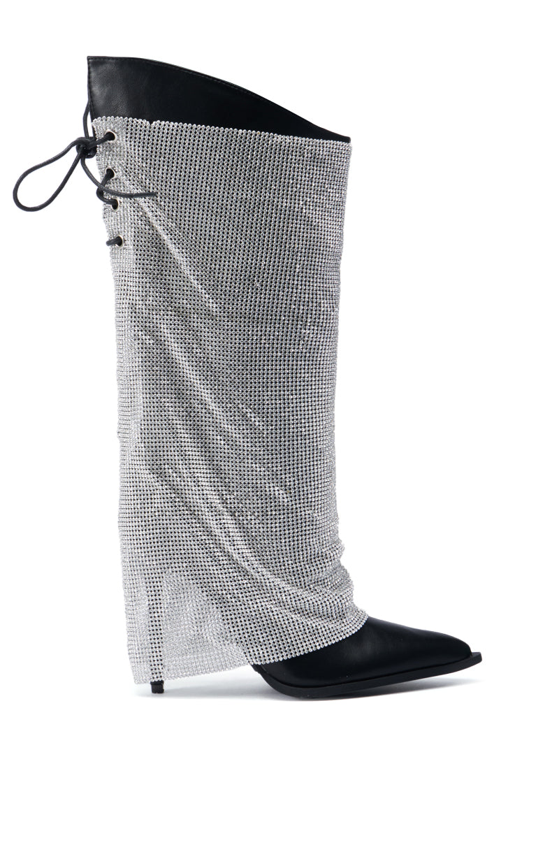 Meet the AZALEA WANG JACLYN Embellished Stiletto Boot in Black, a mesmerizing knee-high boot featuring a pointed toe and adorned with an exquisite rhinestone mesh overlay. This stunning piece showcases an elegant lace-up back, infusing any ensemble with sophistication and allure.