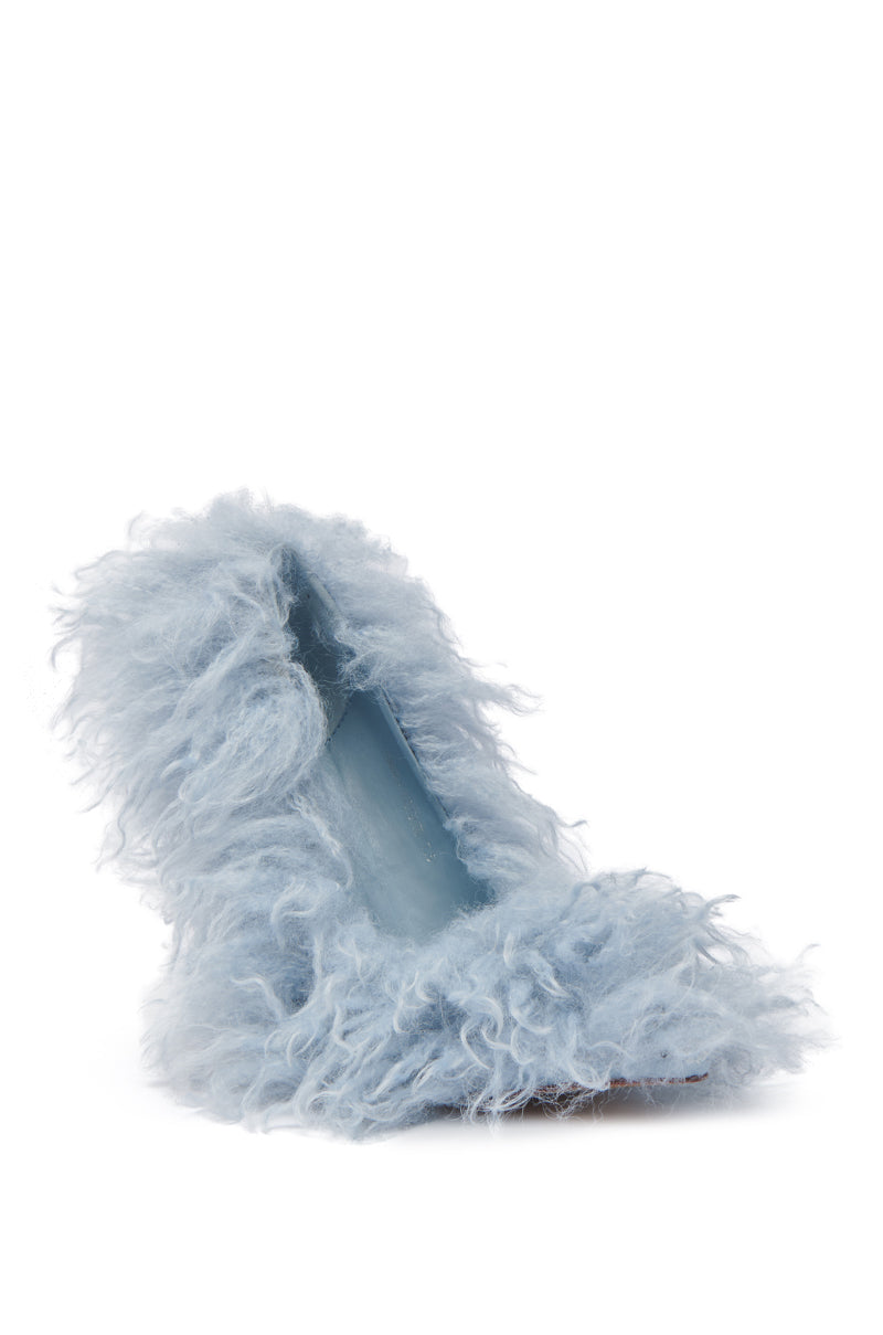 The AZALEA WANG JAMEELA BABY BLUE FUR HEEL is a single high-heeled shoe with fluffy light blue faux fur and a shiny blue insole, featuring a pointed toe pump design that blends playfulness with avant-garde fashion.
