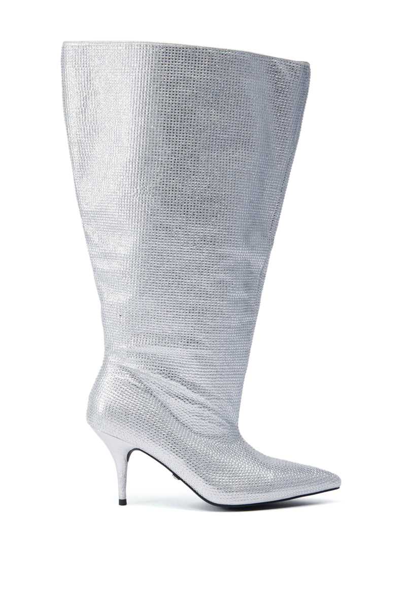 Introducing the AZALEA WANG JARROW SILVER RHINESTONE BOOTIE, a knee-high boot that boasts a pointed toe and stiletto heel, adorned with a textured glitter textile upper for a shimmering finish.