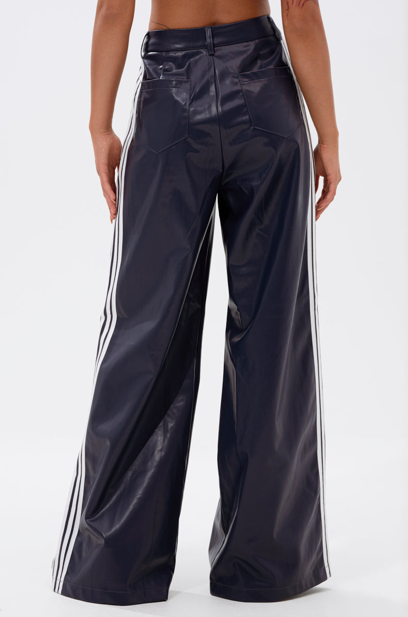 A person shown from the back against a plain white background is wearing DAYTIME LOVIN TROUSER IN NAVY, featuring a high-rise, wide-leg cut.