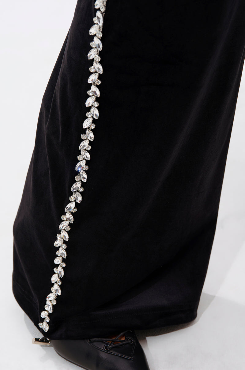 A close-up of the DARA RHINESTONE WIDE LEG SWEATPANT highlights a sparkling line of crystal embellishments along the side seam, with part of a black shoe visible at the bottom.