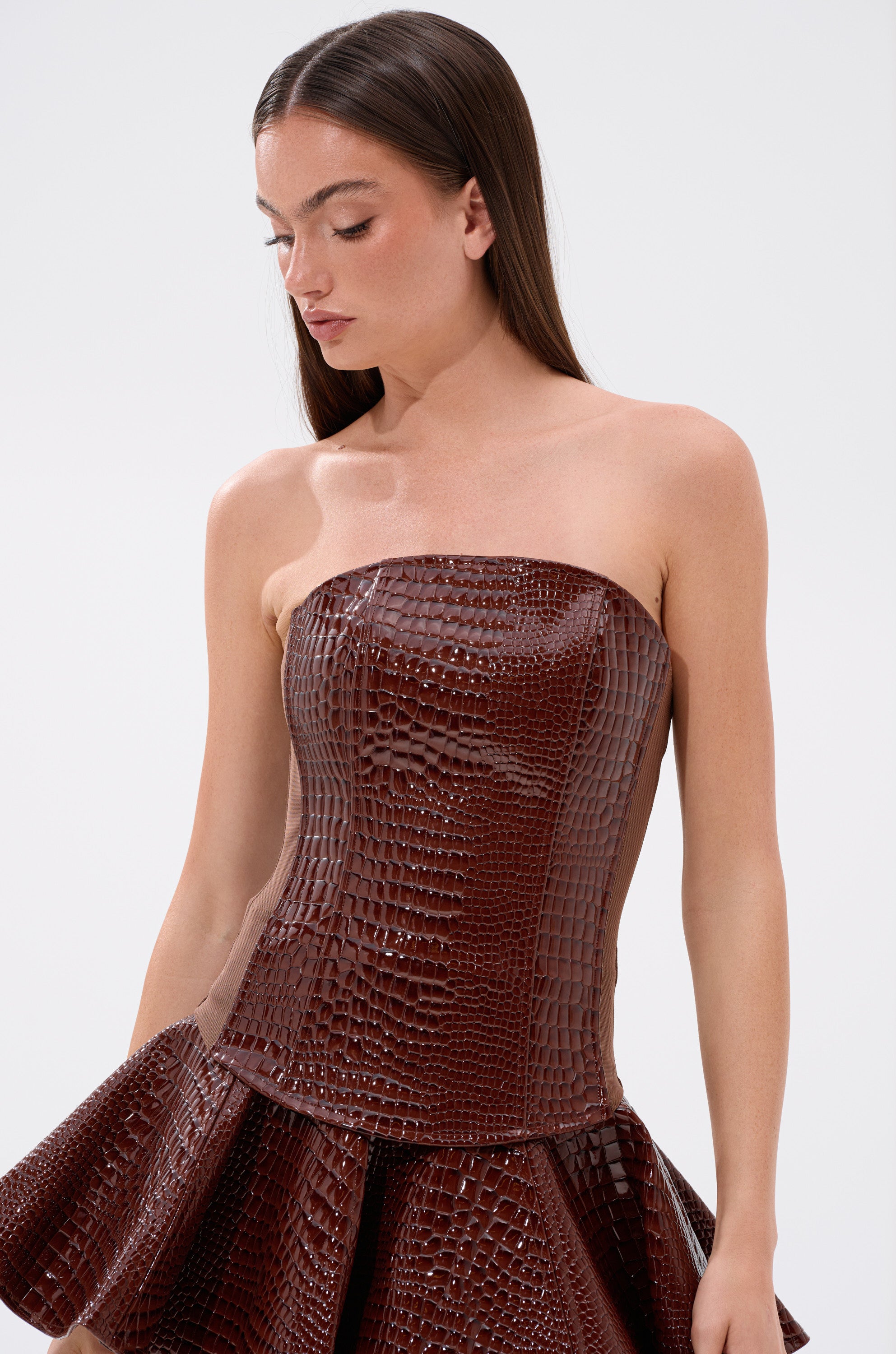 A woman in a brown dress styled with the TOO GOOD FOR YOU CROCODILE CORSET.