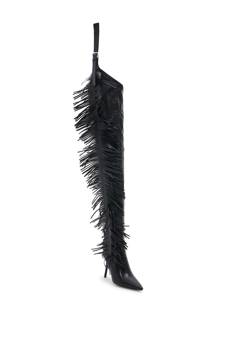 The AZALEA WANG KARTICE BLACK STILETTO WESTERN CHAP BOOT features a knee-high design in sleek faux leather with a pointed toe, stiletto heel, and long fringe along the side, shown against a white background.