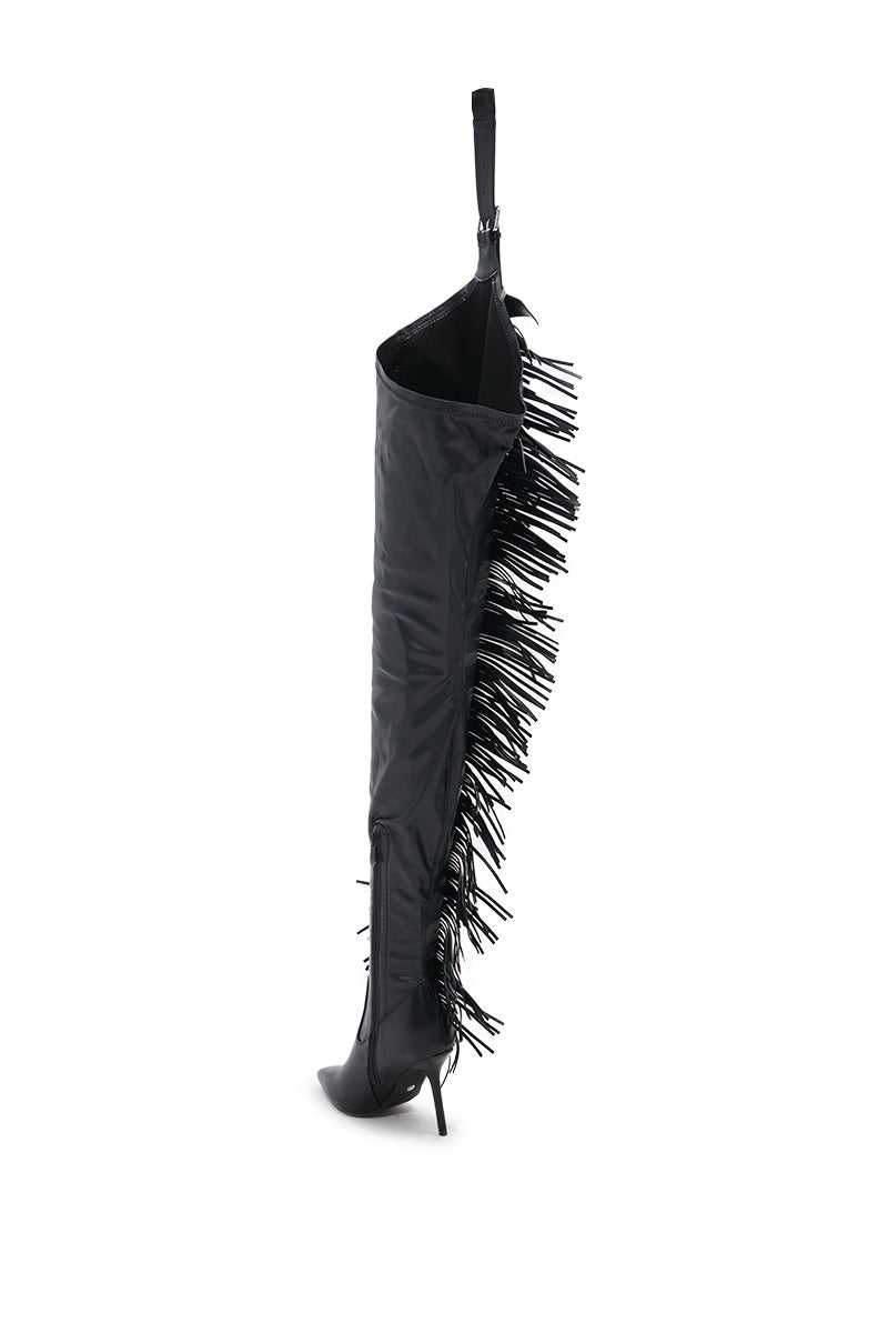 The AZALEA WANG KARTICE BLACK STILETTO WESTERN CHAP BOOT features black faux leather, a pointed toe, stiletto heel, and side fringe, shown solo against a plain white background.