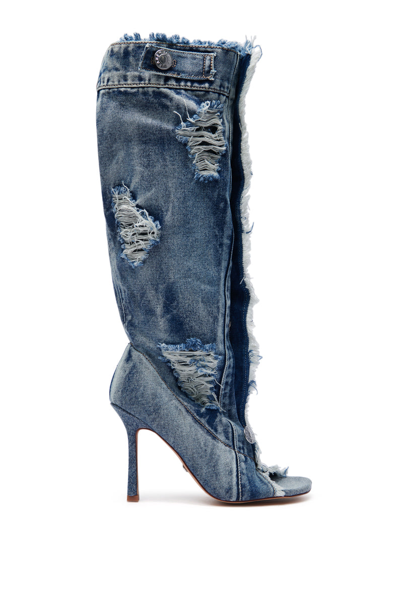 The AZALEA WANG KAZUKI DENIM OPEN TOE BOOT mimics distressed jeans with its blue frayed edges, rips, and a button detail. This high-heeled stiletto boot resembles a denim pant leg and includes a cushion insole for added comfort.