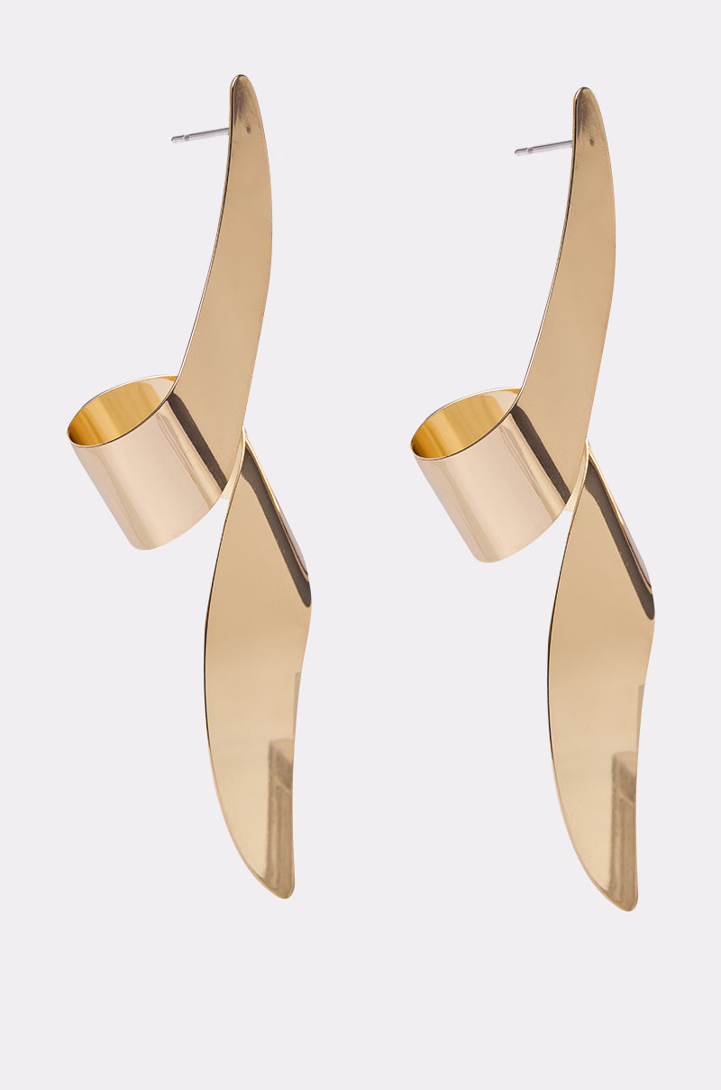 The TWISTED UP EARRING is a modern gold-tone pair with sculptural, curved, and twisted shapes, featuring shiny surfaces and shown against a plain white background.