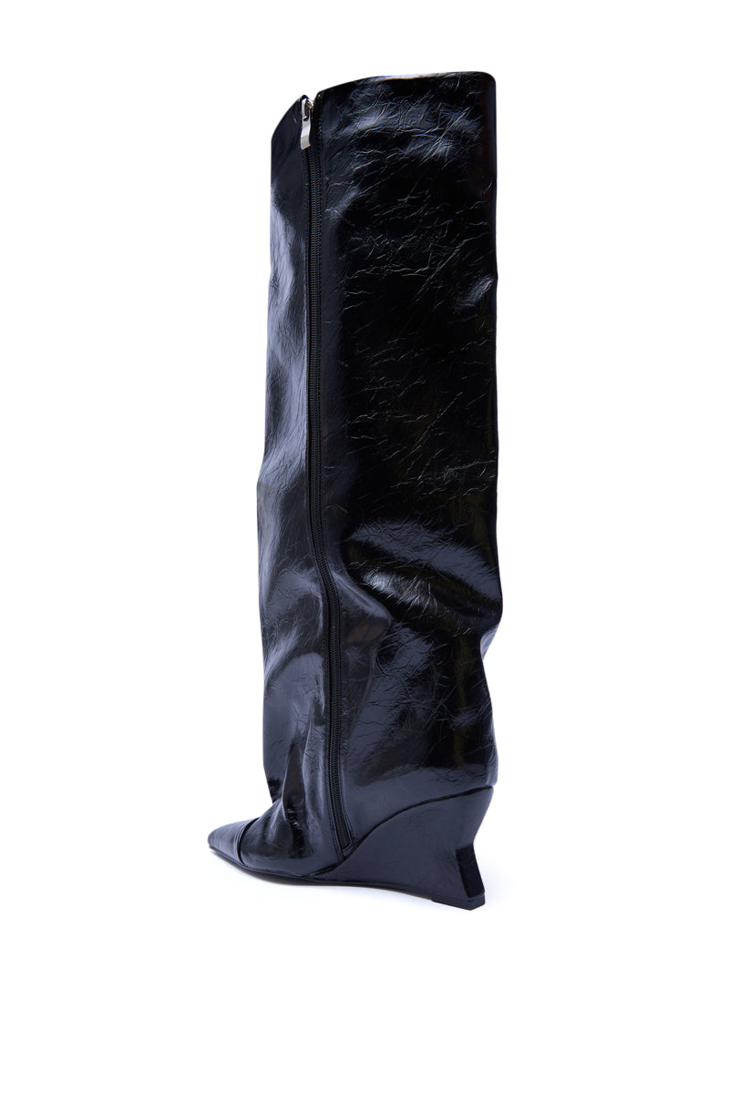 The AZALEA WANG KENYA BLACK KNEE HIGH WEDGE BOOT is shown in shiny black faux leather with a visible side zipper and unique angular heel, displayed against a white background.
