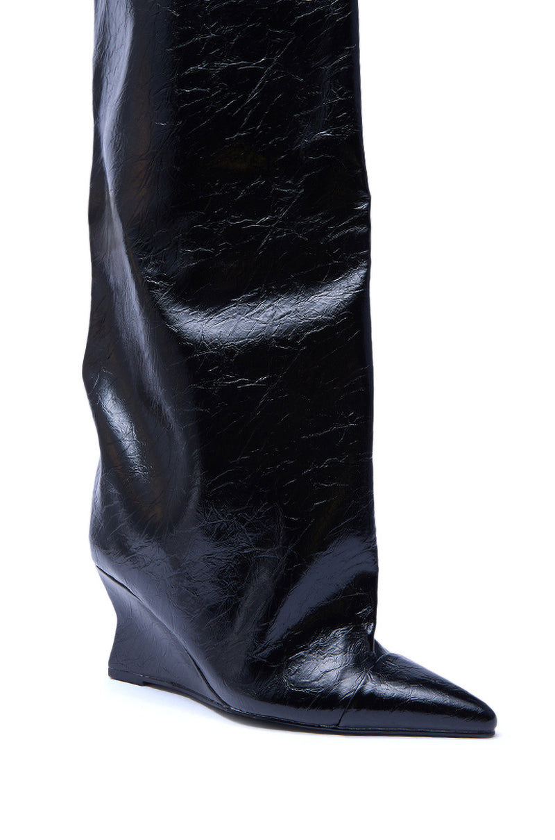 A close-up of the AZALEA WANG KENYA BLACK KNEE HIGH WEDGE BOOT, featuring shiny black faux leather, a pointed toe, and a hidden wedge heel, set against a white background.