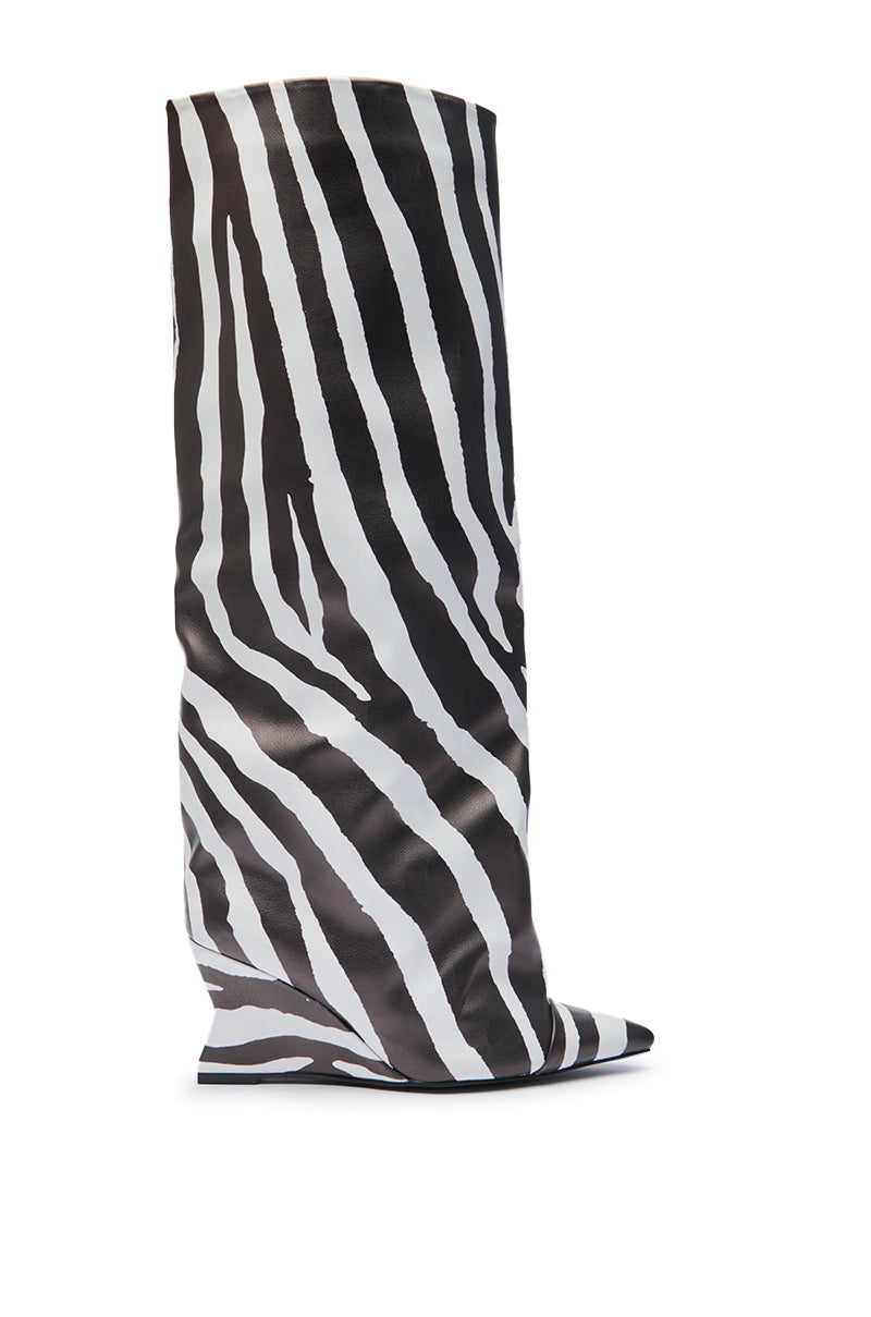 The AZALEA WANG KENYA ZEBRA KNEE HIGH WEDGE BOOT features bold black and white zebra stripes in faux leather—an eye-catching knee-high boot perfect for making a statement. Displayed upright against a white background.