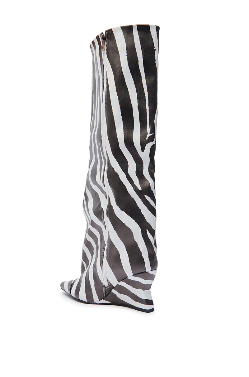 The AZALEA WANG KENYA ZEBRA KNEE HIGH WEDGE BOOT features a black and white stripe pattern, pointed toe, side zipper, low wedge heel, and faux leather material, shown against a plain white background.