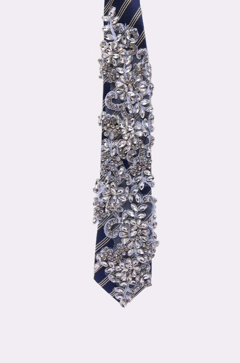 NOT YOUR TYPICAL TIE dazzles with blue diagonal stripes, detailed silver rhinestones, and beaded floral patterns—a sparkling, ornate accessory perfect for elevating your business attire.