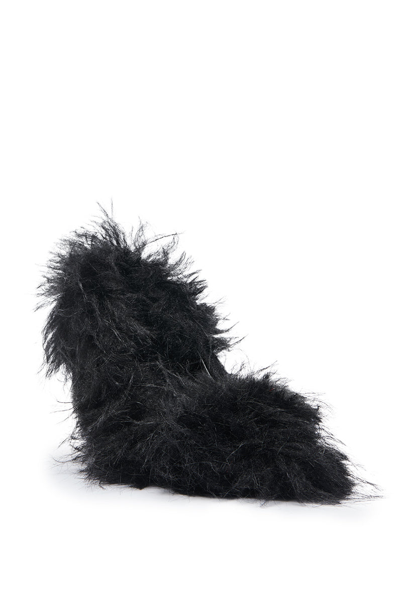 The AZALEA WANG KURT BLACK FUR EMBELLISHED PUMP is a black stiletto heel fully covered in long, shaggy faux fur, showcased against a plain white background.