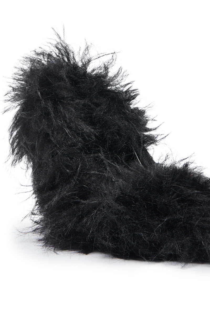 A close-up of the AZALEA WANG KURT Black Fur Embellished Pump, showcasing shaggy textured faux fur details against a white background for a luxurious look.