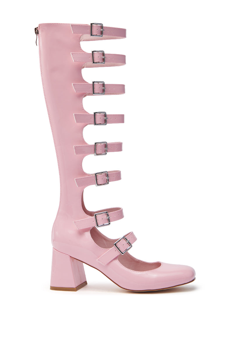 Discover the AZALEA WANG LAIMA Pink Patent Chunky Buckle Boot, featuring a knee-high shaft and chunky heel. With seven buckle straps on its front, this gladiator-style design combines open and closed sections for a bold look.