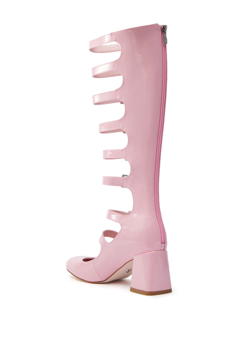 The AZALEA WANG LAIMA PINK PATENT CHUNKY BUCKLE BOOT is a striking pink knee-high gladiator sandal with wide straps, back zipper, open toe, and chunky heel against a white background, capturing an edgy shaft design.
