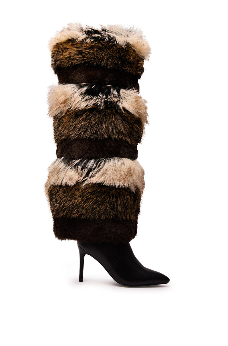 The AZALEA WANG LANGLAU BROWN MULTI STILETTO FUR BOOT features a black pointed toe and high heel, wrapped in thick bands of brown, tan, and white faux fur for a bold, textured style. Shown photographed on a white background.