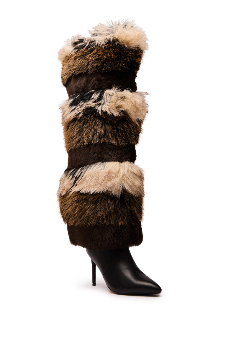 The AZALEA WANG LANGLAU BROWN MULTI STILETTO FUR BOOT is a black, high-heeled thigh-high stiletto with a pointed toe, featuring layered multicolored faux fur bands in shades of brown, tan, and cream.