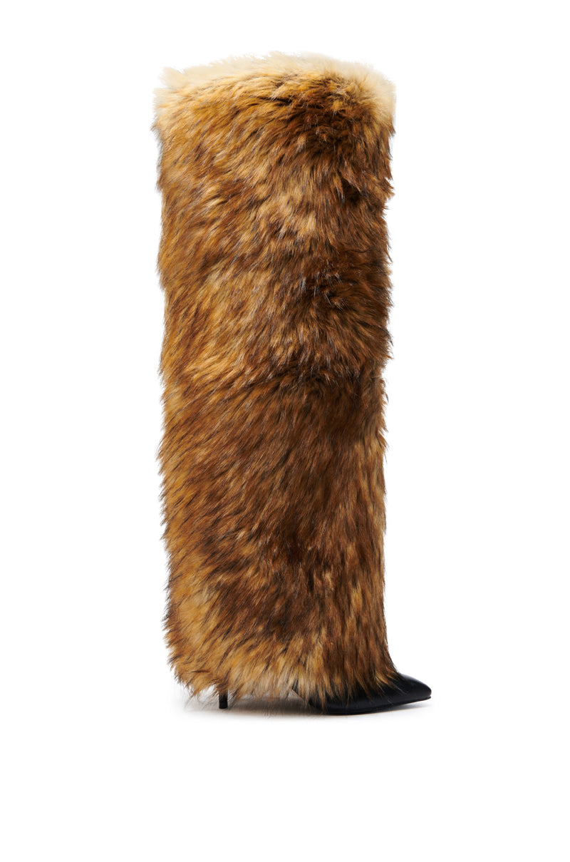 The AZALEA WANG LANGDON BROWN THIGH-HIGH FUR LUXE BOOT is a thigh-high boot covered in brown faux fur with white accents, featuring a pointed black toe and slim stiletto heel.